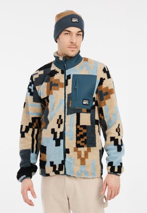Fleece jacket featuring a multicolor abstract pattern in beige, blue, and black, with a front zip and a teal chest pocket. Beanie included.