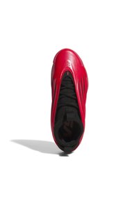 Sneaker rossa con una parte superiore liscia e lucida e lacci in tessuto neri. Presenta distinti rilievi lungo i lati e un'area per la caviglia imbottita per il supporto.