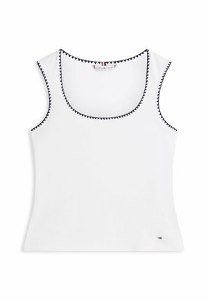 Hvid ærmeløs tanktop med sort zigzagkant på halsudskæring og ærmegab, med en lille Tommy Hilfiger-logo nær kanten.