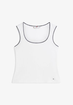 Weißes ärmelloses Tanktop mit schwarzem Zickzackbesatz am Ausschnitt und an den Armausschnitten, mit einem kleinen Tommy Hilfiger-Logo nahe dem Saum.