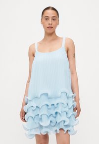 Light blue sleeveless dress with a pleated texture, featuring layered ruffle accents at the hem for added volume and detail.