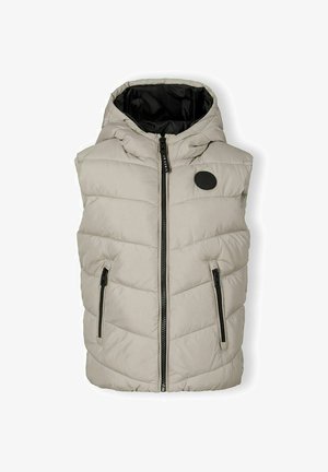 Šviesiai rudas pūkų liemenė su kapišonu, su horizontaliu siūliniu dizainu, dviem užtrauktukais užsegamomis šoninėmis kišenėmis ir juodu vidiniu pamušalu. Juodas logotipas krūtinėje.