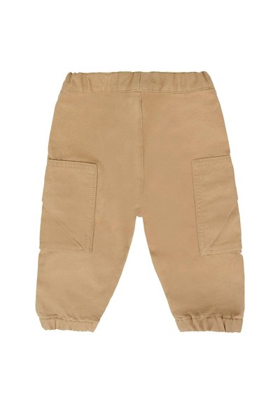 Pantalons en mélange de coton beige avec une texture douce. Dispose d'une taille élastique, de deux grandes poches latérales et de poignets élastiques aux chevilles.