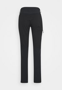 Svart utendørs bukser med en elastisk, glatt tekstur. Har en bred linning, tapered ben og glidelås-lommer som detaljer.