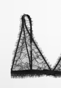 Black lace bralette with triangular cups, delicate floral patterns, and frayed edges. Thin adjustable straps and a soft textured finish.