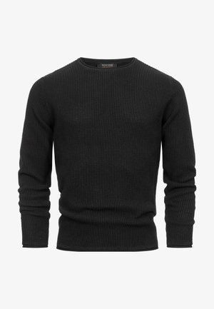 Zwarte gebreide trui met lange mouwen, ronde nek, wafelstructuur en ribgebreide manchetten en zoom. Eenvoudig ontwerp zonder zichtbare versieringen.