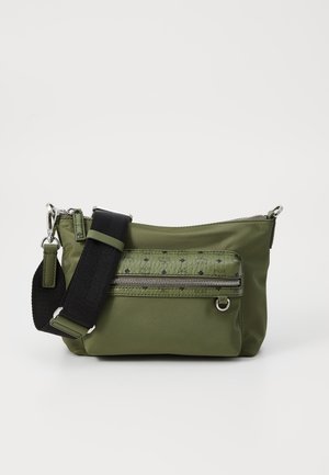 Green nylon shoulder bag with a front zip pocket, textured pattern, adjustable black strap, and silver hardware accents.