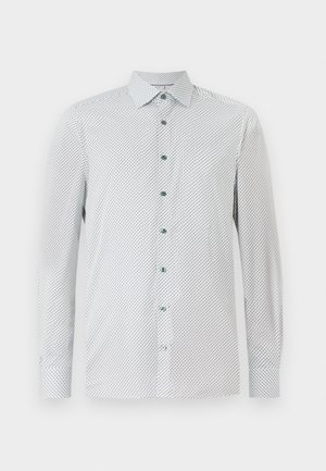 Hvit langermet skjorte med et lite svart geometrisk mønster, grønne knapper og spiss krage. Vanlig passform med knappede mansjetter.