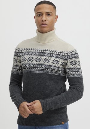 Knitted turtleneck sweater featuring beige and dark gray colors with a snowflake pattern across the chest, ribbed cuffs, and hem.