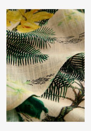 Tissu à motif floral avec des fougères vertes et des fleurs jaunes sur un fond texturé beige. Matériau léger et doux.
