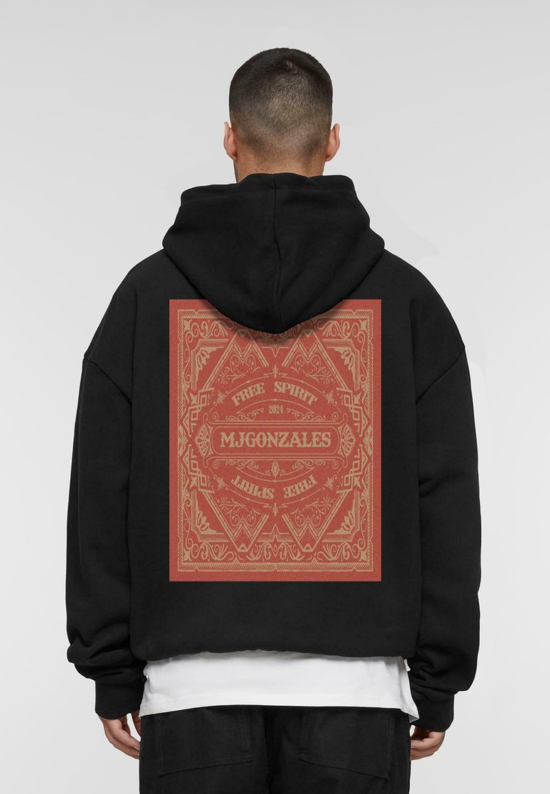 Black hoodie with a large red graphic on the back featuring intricate border designs and text reading "MJGONZALES" and "FREE SPIRIT 2024."