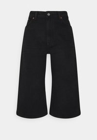 Jean noir à jambes larges en denim de coton, doté d'une taille haute, d'un design à cinq poches, et de surpiqûres orange contrastantes sur les poches.