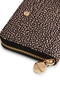 Printed zip wallet featuring a textured black and beige pattern, gold zipper, and a circular gold zipper pull with branding detail.