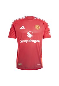 Maillot de football rouge de Manchester United avec des accents blancs, doté d'un col rond, de manches courtes et de logos de marque. Tissu léger.