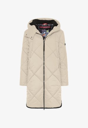 Long beige quilted parka with a hood, front zipper, and black accents. Features diamond patterns and plush interior lining.