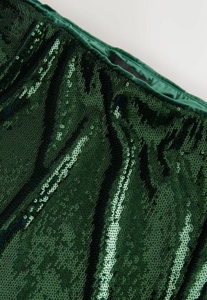 Grüner Paillettestoff mit glatter Textur und einer glänzenden, reflektierenden Oberfläche. Bündchen aus dunklerem grünen Satin gefüttert.