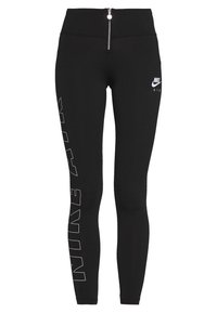 Svarta Nike Air tights med hög midja och blixtlås, vitomkretsad "NIKE AIR"-text vertikalt på vänster ben och Nike-logotyp på höger lår.