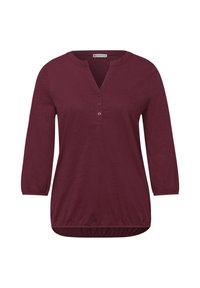 Bluse i blommefarve med lange ærmer, tre knapper, rund halsudskæring med hak samt elastiske manchetter og kant.