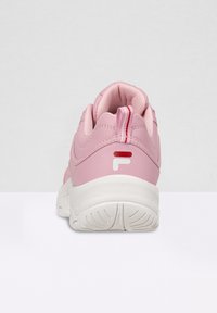 Pink sneaker with a smooth synthetic upper, white midsole, and textured outsole. Features a red and white pull tab and logo detail.