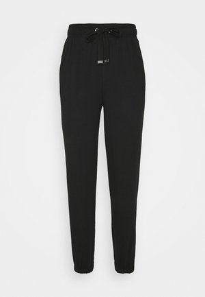 Zwarte joggingbroek van zacht stof, met een elastische tailleband met trekkoord en taps toelopende boorden bij de enkels.
