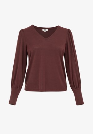 Top de manga larga en tono burdeos con escote en V, con mangas abullonadas y puños ajustados, confeccionado en una suave tela texturizada. Diseño de silueta simple y relajada.