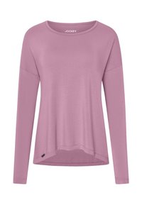 Długi rękaw bluzki w jasnoróżowym kolorze, z okrągłym dekoltem, luźnym krojem i zaokrąglonym dołem z małą metką z boku.