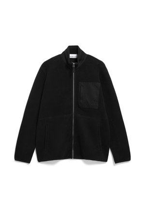 Black fleece zip-up jacket with a high collar, front pockets, and a patch pocket on the left chest. Soft texture and minimal design.