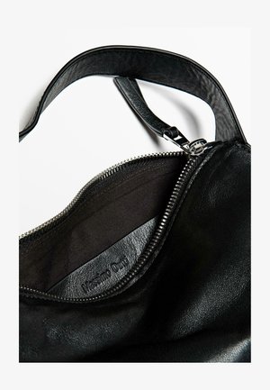 Black leather handbag interior featuring a zip closure, smooth texture, and subtle embossed logo. Strap connected at the top.