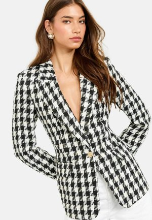 Black and white houndstooth blazer with a tailored fit, deep V-neck, two front pockets, and a single gold button accent.