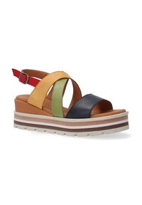 Multicolor sandal featuring yellow, green, black, and red leather straps, a chunky platform sole, and adjustable ankle strap with metal buckle.