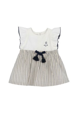 Biały top z granatowymi, marszczonymi rękawami, zdobiony haftem kotwicy. Spódnica w paski z granatową kokardą i frędzlami. Materiał bawełniany.