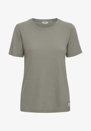 T-shirt à manches courtes, col rond, de couleur vert muted, avec un tissu texturé arborant un motif en grille. Petite étiquette logo en bas à gauche.