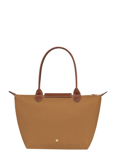 Tan tote bag made of nylon with brown leather handles and accents. Features a zip closure and a flat front pocket for storage.