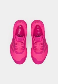 Pink athletic shoes made of breathable mesh with a textured surface, featuring three stripe design and padded tongue for comfort.
