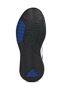 Suela de zapatilla de goma negra con patrones de tracción multidireccionales. Presenta un acento azul en el área del talón, proporcionando estabilidad para la tracción.