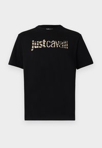 T-shirt nera in cotone con un distintivo logo "justcavalli" in oro metallico sul petto in un carattere stilizzato. Maniche corte, colletto rotondo.