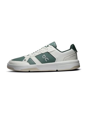 White and green low-top sneaker with lace closure, perforated toe, logo on the side, and a thick white sole. No people or background.