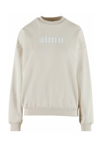 Beige Sweatshirt mit geripptem Rundhalsausschnitt, oversized Passform und elastischen Bündchen. Auf der Vorderseite befindet sich ein weißes Logo mit Text- und Datumsangaben.
