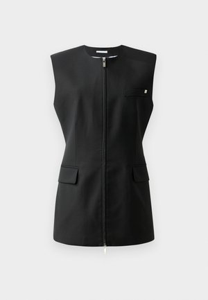 Veste sans manches noire avec fermeture éclair à l'avant, deux poches avant et un petit détail accentué. Fabriquée en tissu lisse.