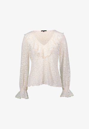 Blouse en dentelle de couleur crème avec des manches longues, un décolleté en V, un devant froncé et des poignets évasés ornés de dentelle. Motif floral texturé sur l'ensemble.