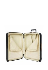 Valigia nera con interni crema, dotata di doppi scomparti, cinghie incrociate elastiche e una maniglia in pelle. Inclusi tasche con zip.