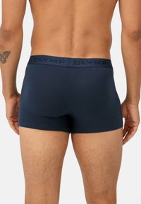Boxer-briefs bleu marine foncé avec une texture douce et une ceinture élastique logotée. La coupe est ajustée, améliorant le confort et la forme.