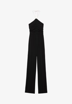 Černý overal na ramínka s nařasenými detaily na těle, širokými nohavicemi a nastavovacími tkaničkami. Vyrobeno z měkké a pružné látky.