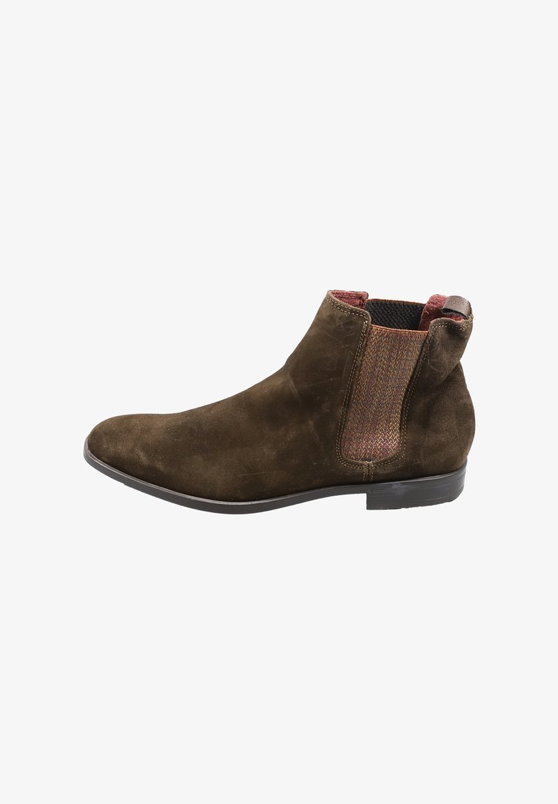 Brauner Wildleder-Stiefelette mit elastischen Seitenpaneelen in gewebter Textur. Flache Ledersohle, abgerundete Zehenpartie und minimalistisches Design.