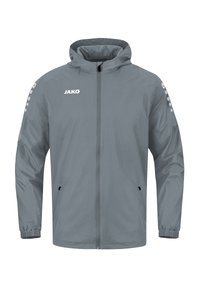 Veste coupe-vent grise avec une fermeture éclair à l'avant, deux poches latérales, des poignets élastiques et le logo "JAKO" sur la poitrine. Matériau lisse et léger.