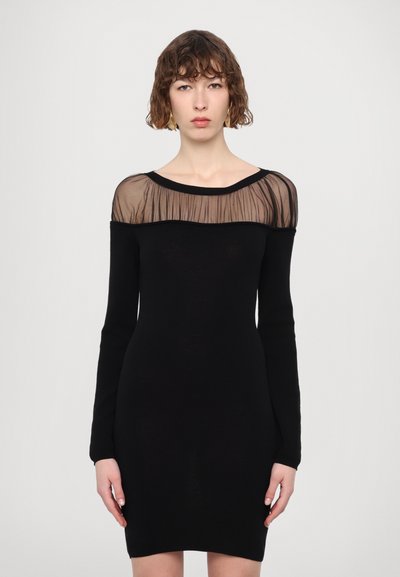 Schwarzes Kleid mit langen Ärmeln und einer transparenten schwarzen Netz-Ausschnitt, das eine taillierte Silhouette und eine glatte Textur aufweist.