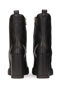 Black leather ankle boots with a chunky high heel, featuring a side zipper and pull tab at the back, smooth texture and sleek design.