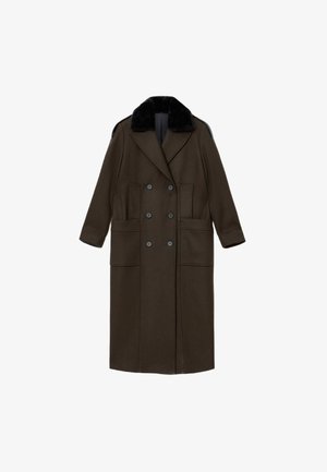 Long, double-breasted coat in dark olive green fabric, featuring a black fur collar, two front pockets, and a tailored silhouette.