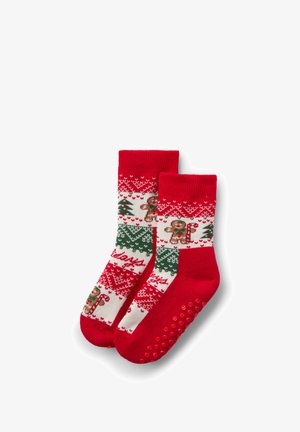 Calzini rossi a tema natalizio con motivi bianchi e verdi che raffigurano omini di pan di zenzero e alberi di Natale; suole rosse testurizzate con puntini antiscivolo.