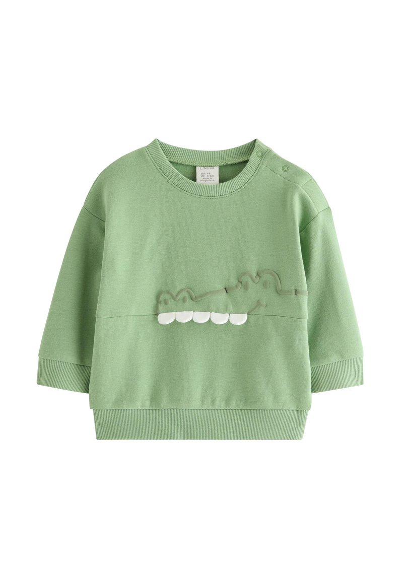 Πράσινο βαμβακερό φούτερ με στρογγυλή λαιμόκοψη, μακριά μανίκια και υφή κροκοδείλου με λευκές λεπτομέρειες στα δόντια.